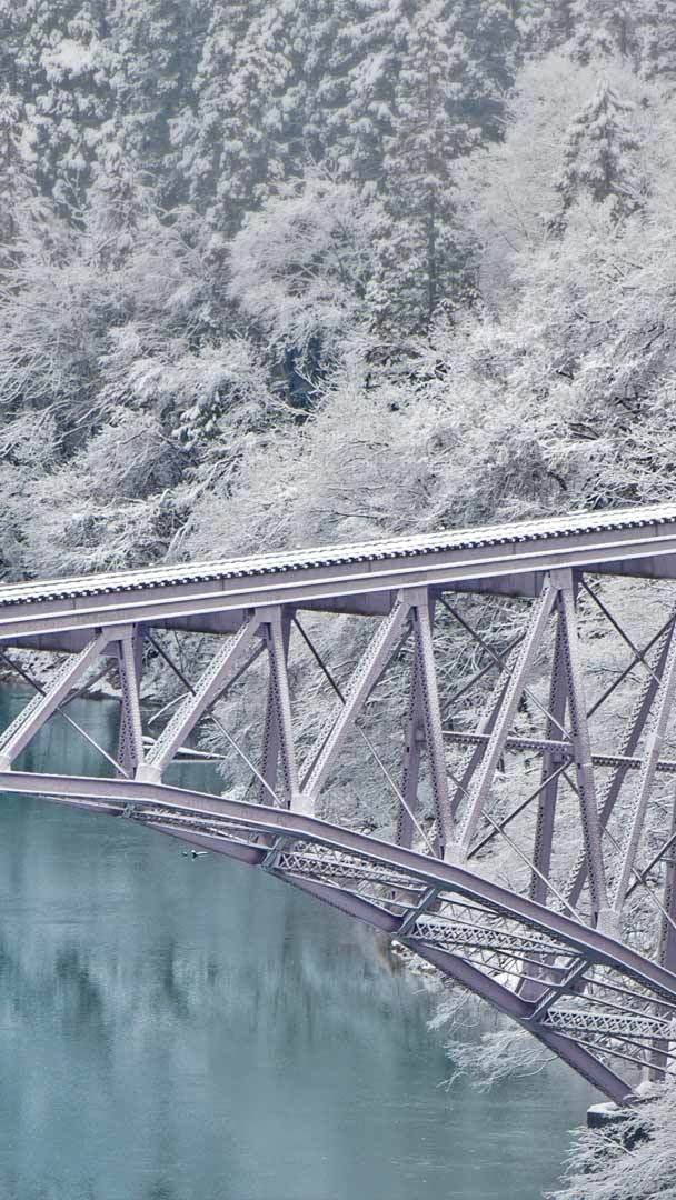 Train crossing the Tadami River in Japan