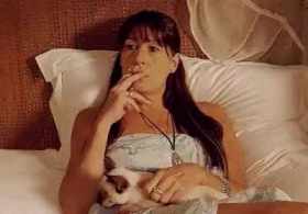 Woman smoking on bed and cat in arms short MP4 video