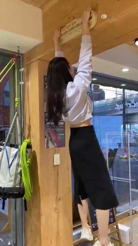 Girl in white shirt and black skirt doing pull ups short MP4 video