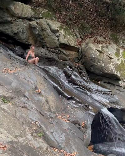 Sydney Sweeney slides into the water in bikini