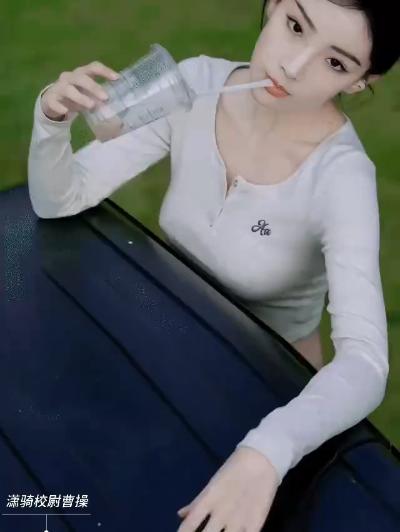 Woman biting a straw and not wearing a bra