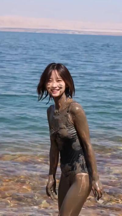 Beautiful girl covered in Dead Sea mud