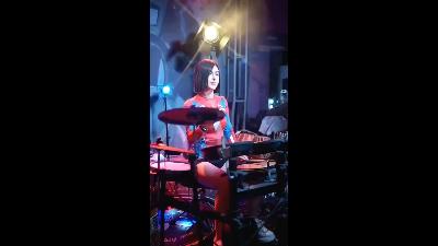 Beautiful short-haired girl plays the drums coolly