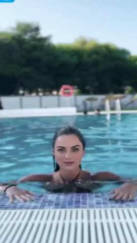Leaning out of the swimming pool, breasts trembling short MP4 video
