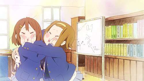 Two girls pinch each other's faces GIF