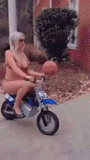 Ride bike shooting a basketball in a bikini short MP4 video