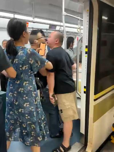 Two men quarreling on the subway GIF