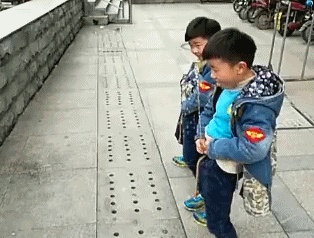 Two kids compete to pee GIF
