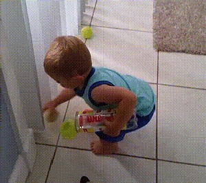 child picking up ball GIF