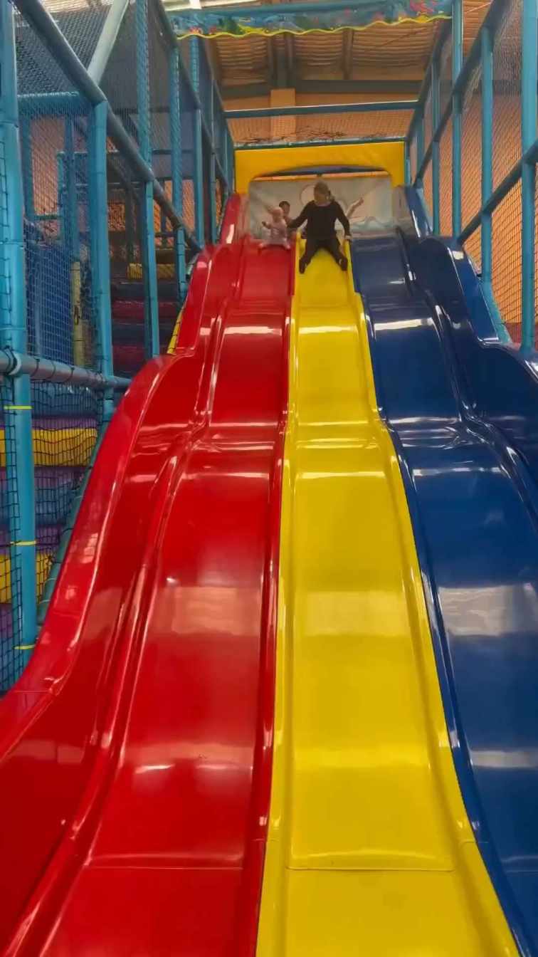 Little girl riding the slide with her toy doll short MP4 video