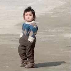 rural little girl walking with hands in pockets GIF
