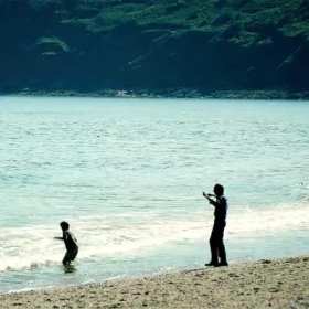 Father and son playing on the beach short MP4 video