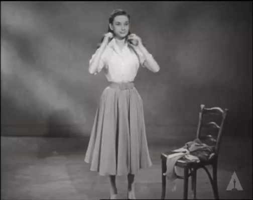Audrey Hepburn adjusts her scarf and spins in circles short MP4 video