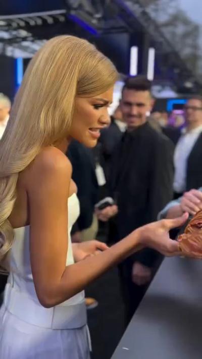 Zendaya received "a huge croissant" from a fan on the red carpet today GIF