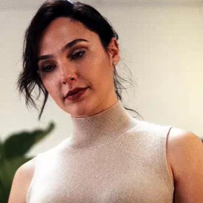 Gal Gadot shakes her head and sighs in "Red Notice"