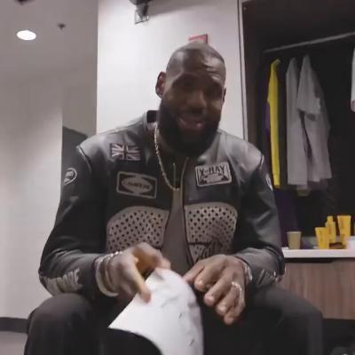 LeBron James holding a white piece of paper with 40,000 written on it