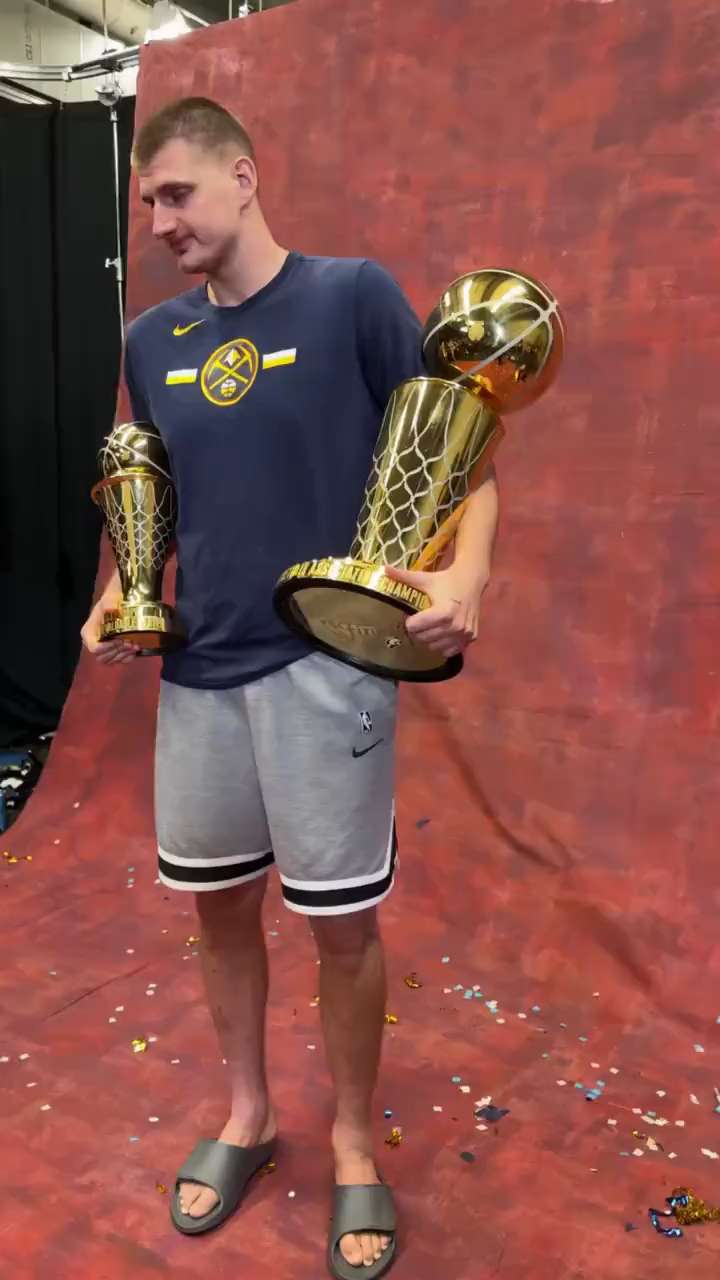 Jokic takes a photo with the trophy short MP4 video