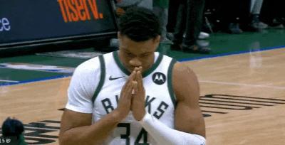 Antetokounmpo puts his hands together and makes a wish before the game