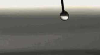 High speed footage captures water droplets falling into water GIF