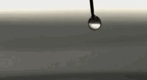 High speed footage captures water droplets falling into water GIF