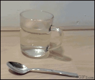 A gallium spoon melts in hot water GIF