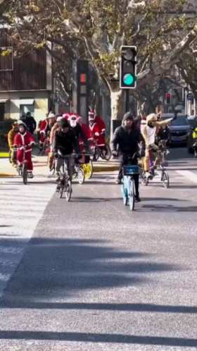 Shanghai, people are dressed as Santa Claus to ride a bicycle to celebrate Christmas short MP4 video
